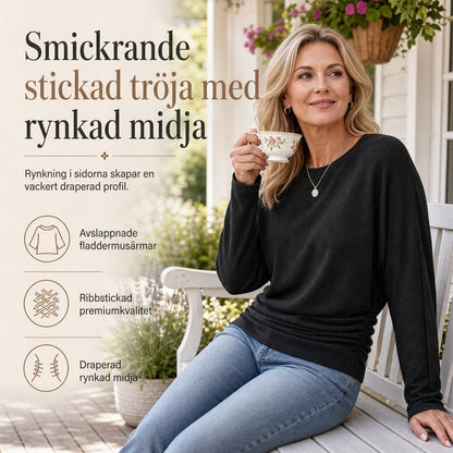 Mjuk stickad tröja för dam med fladdermusärm och smickrande midjedetalj