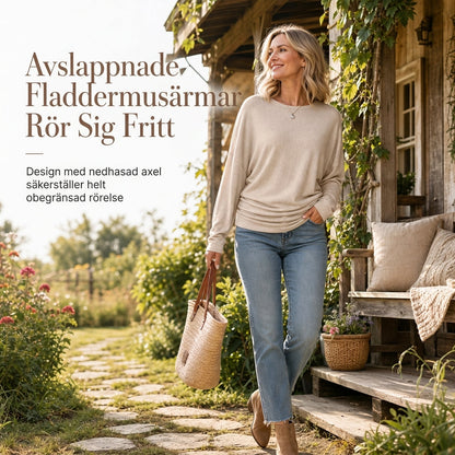 Mjuk stickad tröja för dam med fladdermusärm och smickrande midjedetalj