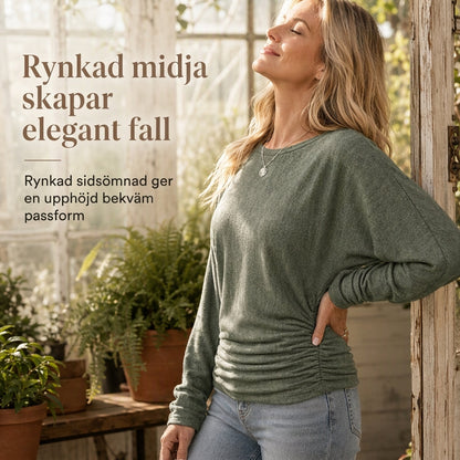 Mjuk stickad tröja för dam med fladdermusärm och smickrande midjedetalj